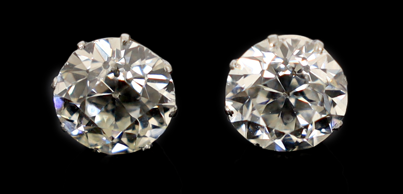 A pair of early 20th century platinum and claw set diamond ear studs